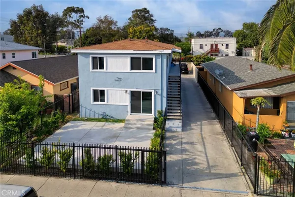 aerial view of a house with yard and staircase