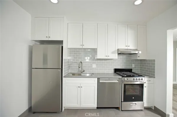 a kitchen with a white cabinets and white appliances