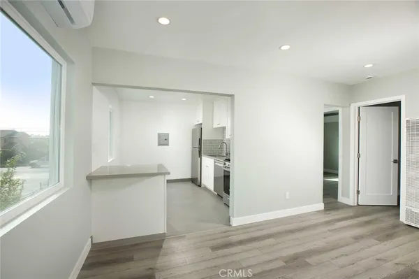 a view of a kitchen with a refrigerator and window