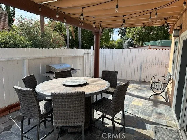 a table and chairs with the view of small roof