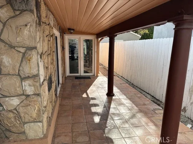 a view of a porch with wooden floor and fence