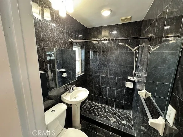 a bathroom with a sink toilet and shower
