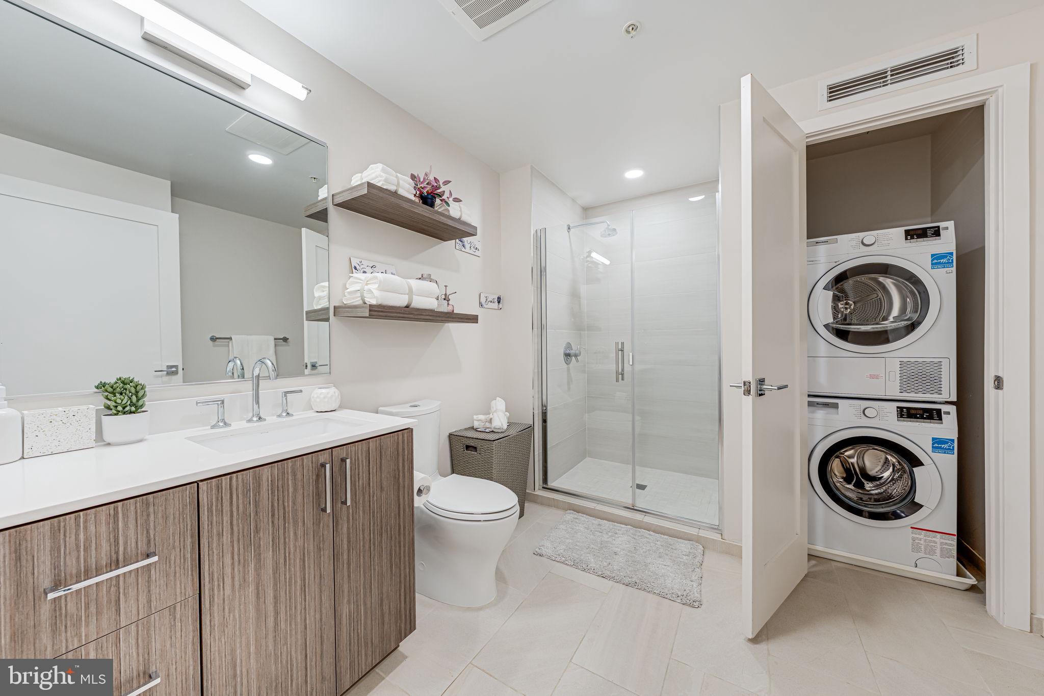 1211 Van Street Southeast, Unit 309 Washington, DC 20003 - Photo 14 of 66 a bathroom with a sink a toilet and a shower