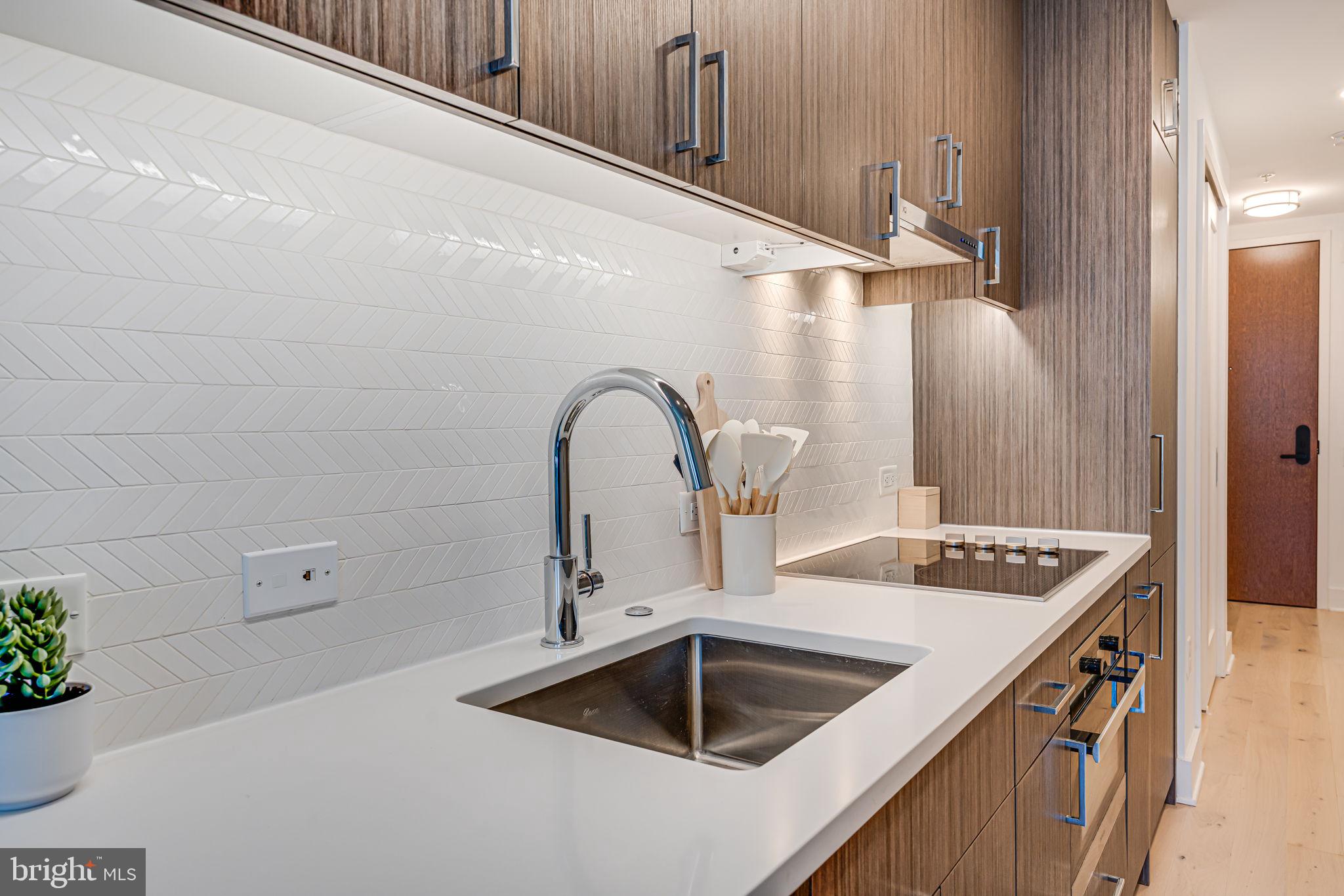 1211 Van Street Southeast, Unit 309 Washington, DC 20003 - Photo 20 of 66 a kitchen with a sink and a refrigerator