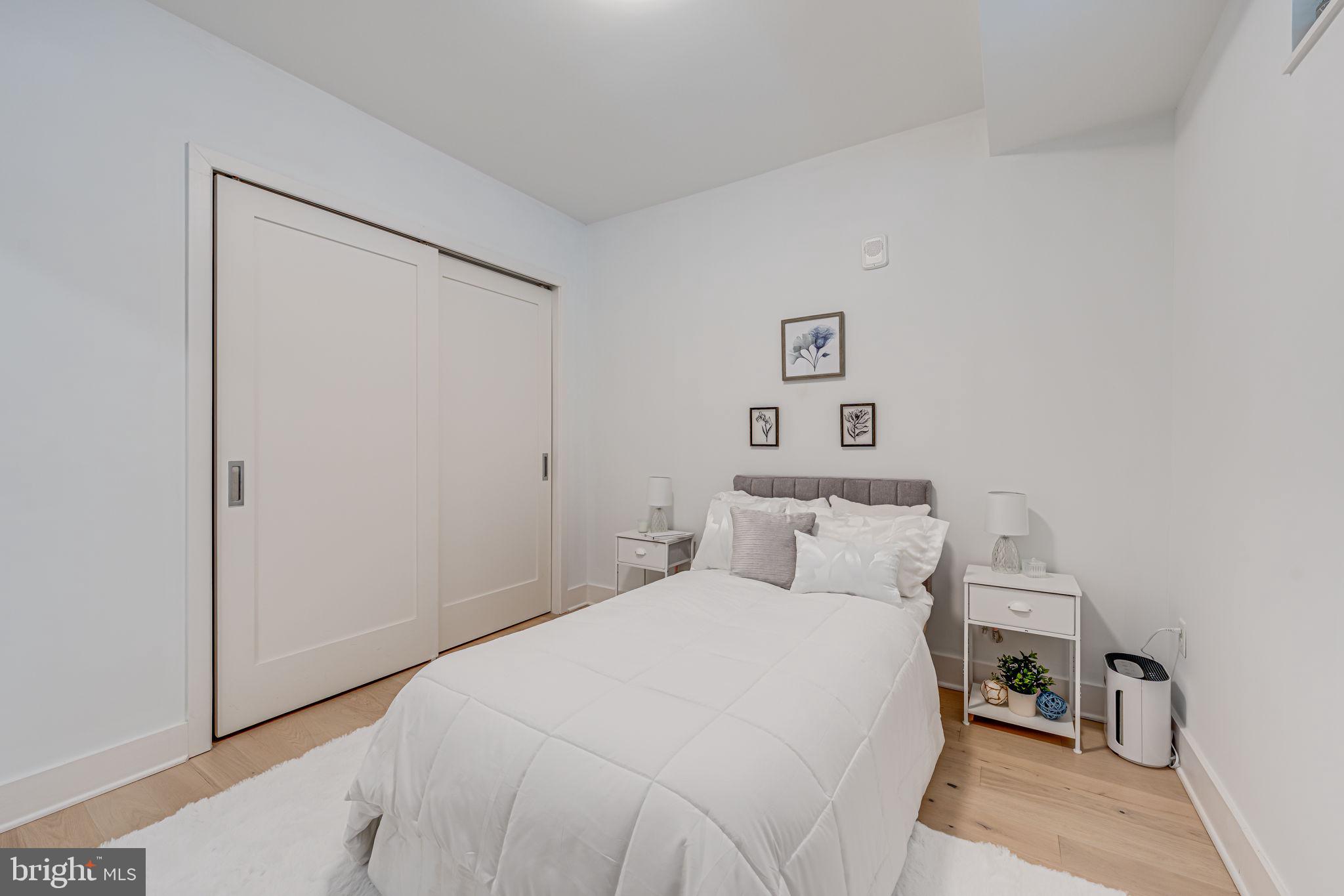 1211 Van Street Southeast, Unit 309 Washington, DC 20003 - Photo 27 of 66 a bedroom with a bed and a night stand