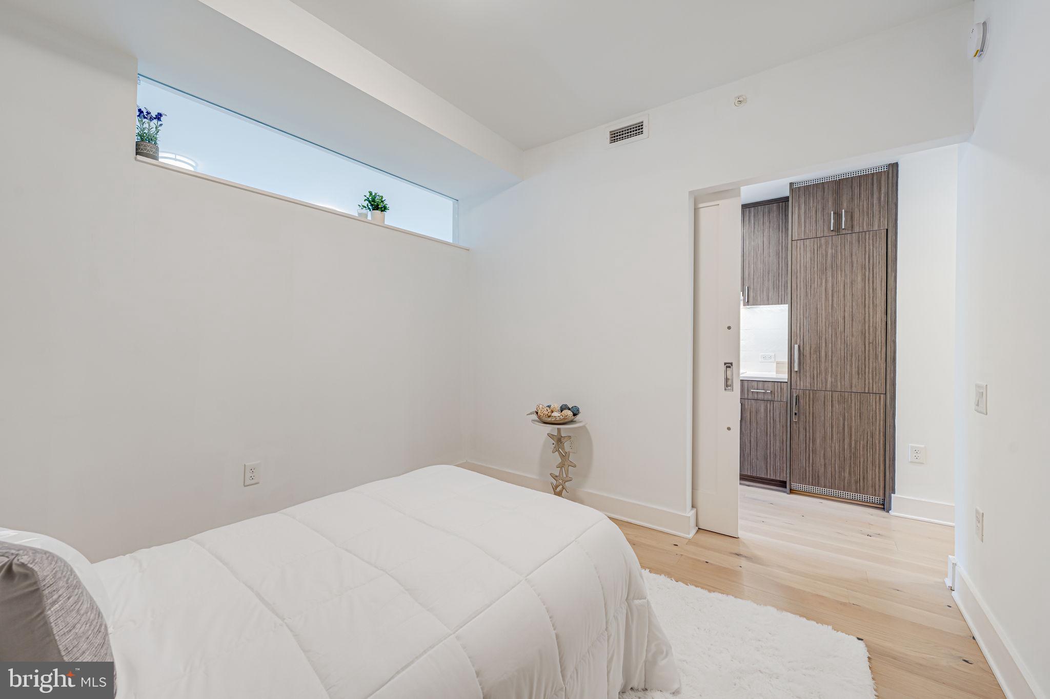 1211 Van Street Southeast, Unit 309 Washington, DC 20003 - Photo 28 of 66 a bedroom with a bed and bathroom