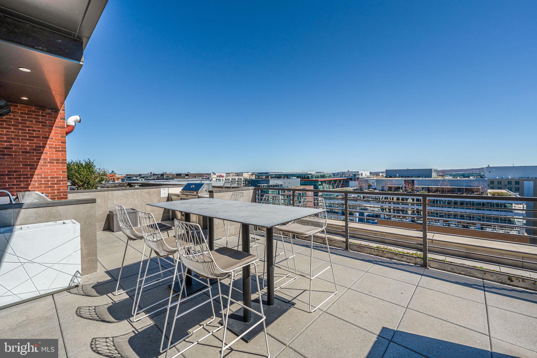 1211 Van Street Southeast, Unit 309 Washington, DC 20003 - Photo 44 of 66 a view of a terrace with furniture and stove