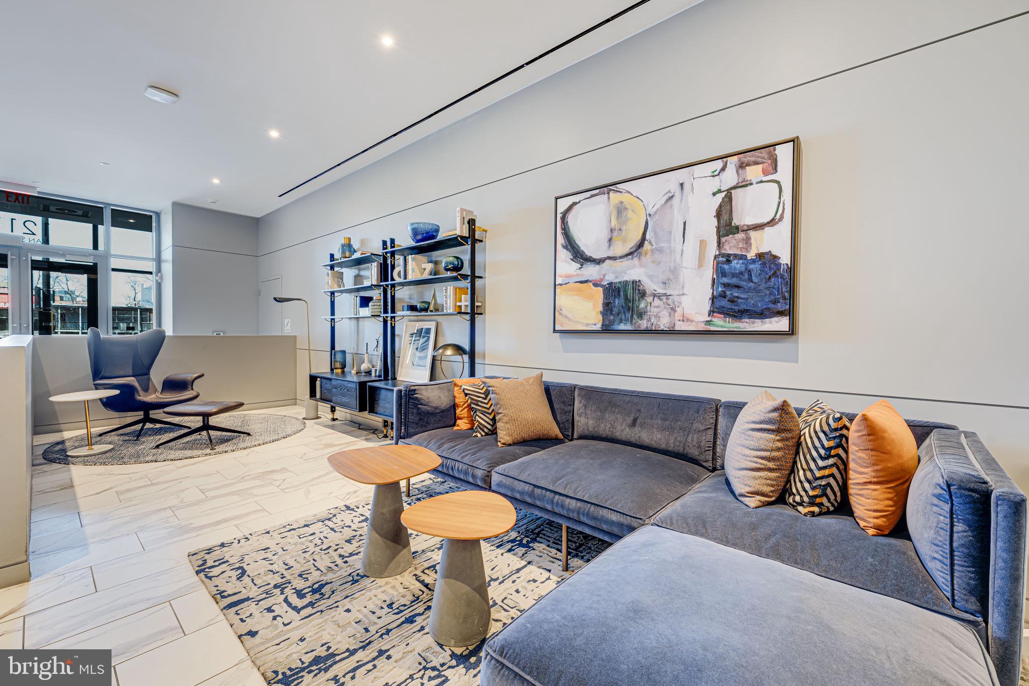 1211 Van Street Southeast, Unit 309 Washington, DC 20003 - Photo 7 of 66 a living room with furniture and book shelf