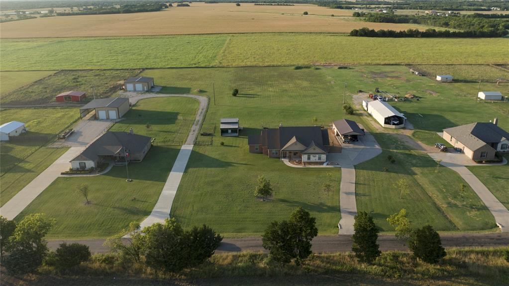 1836 County Road 5005 Blue Ridge, TX 75424 - Photo 28 of 28 Expansive property featuring a residence with a covered front porch, a separate multi-bay garage structure, and a large covered open-sided structure