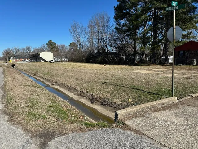 a view of a yard with wooden fence
