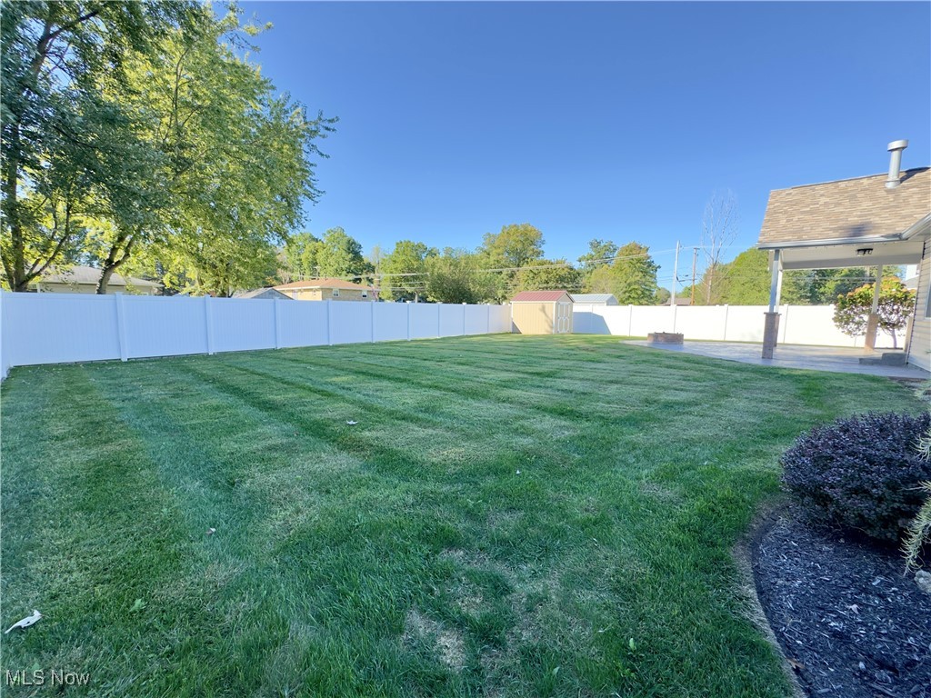 6014 Wentworth Road Southwest Canton, OH 44706 - Photo 20 of 22 Fenced backyard featuring a storage unit and a patio