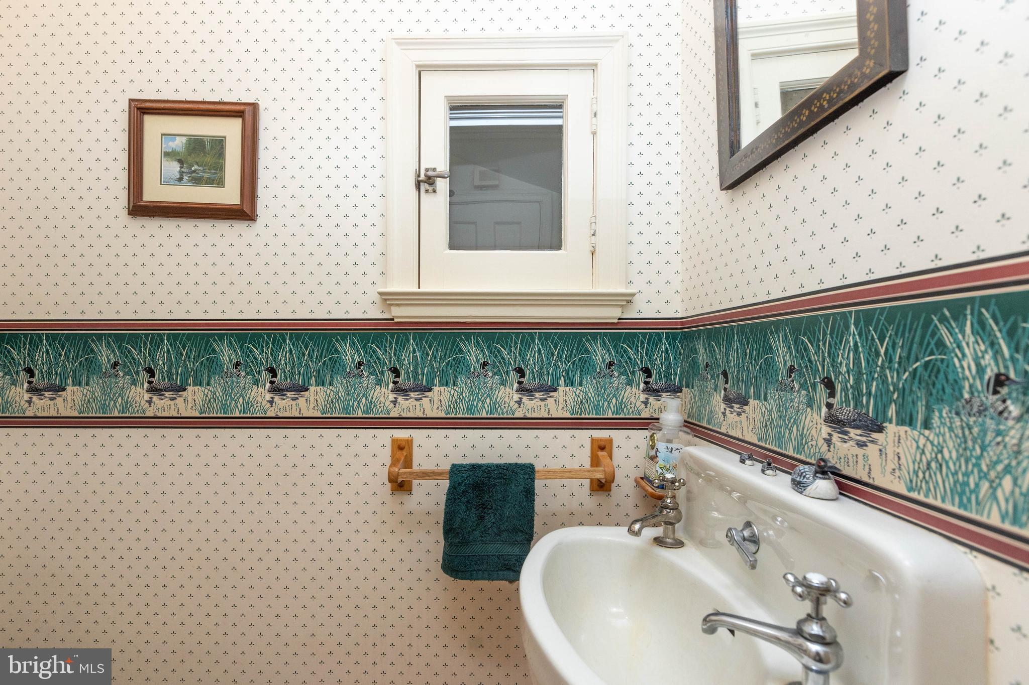 114 Bellemore Road Baltimore, MD 21210 - Photo 24 of 49 a bathroom with a sink and a mirror