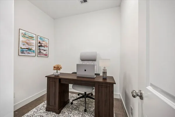a living room with furniture a flat screen tv and a wall painting