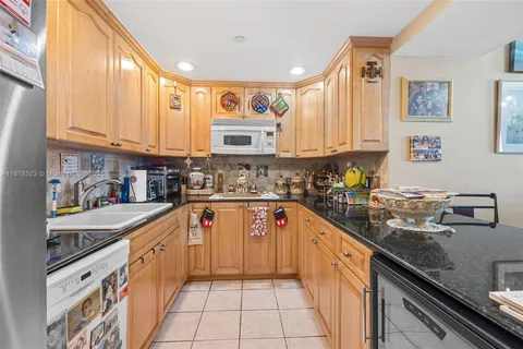 a kitchen with stainless steel appliances granite countertop a sink and cabinets
