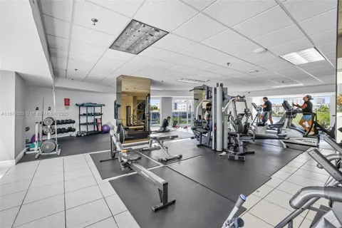 a view of swimming pool with seating space and palm tree