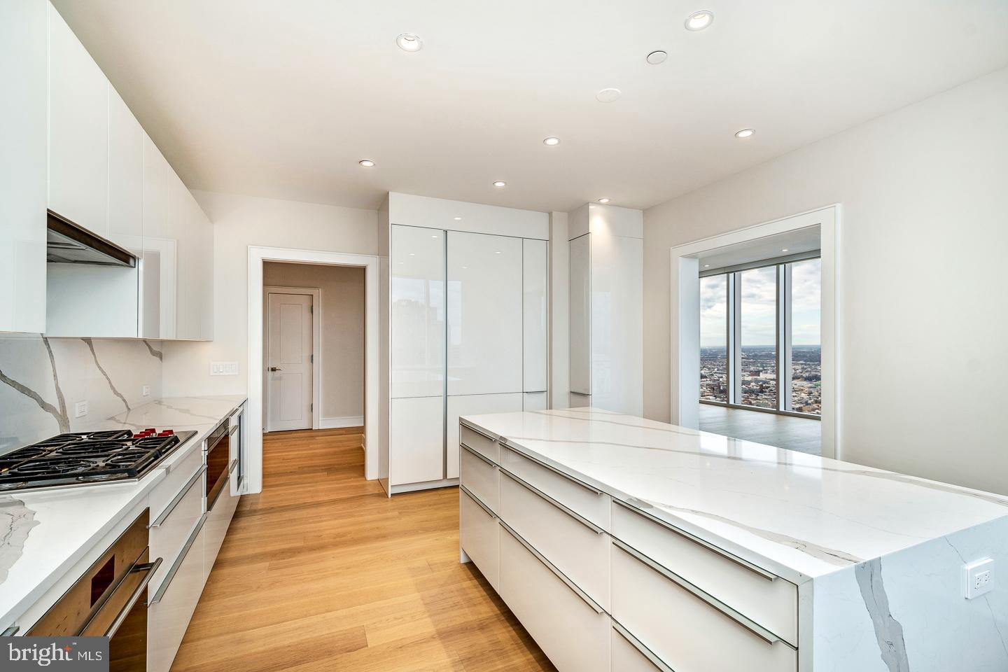 301 South Broad Street, Unit 4001 Philadelphia, PA 19107 - Photo 15 of 84 a large kitchen with stainless steel appliances a large counter top a stove and a refrigerator