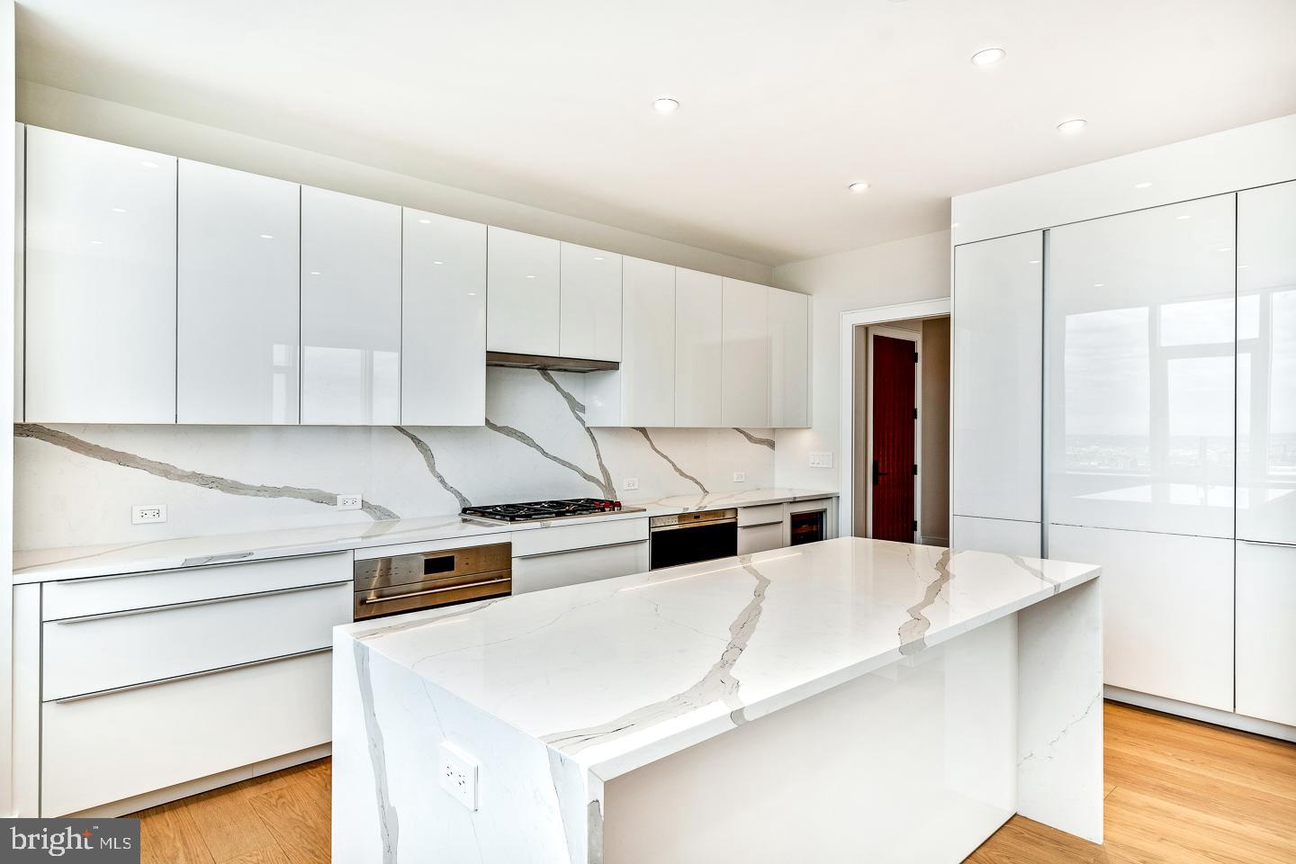 301 South Broad Street, Unit 4001 Philadelphia, PA 19107 - Photo 23 of 84 a kitchen with stainless steel appliances kitchen island a white counter top space cabinets and a window