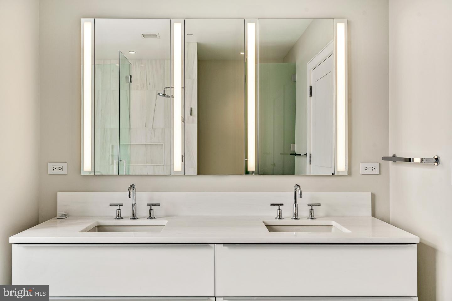 301 South Broad Street, Unit 4001 Philadelphia, PA 19107 - Photo 37 of 84 a bathroom with a granite countertop sink vanity and a mirror