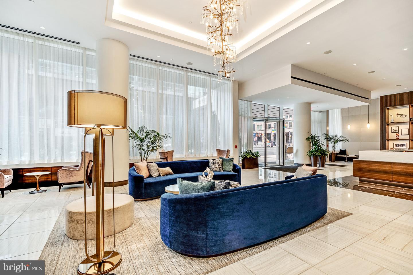 301 South Broad Street, Unit 4001 Philadelphia, PA 19107 - Photo 4 of 84 a living room with a couch and a chandelier