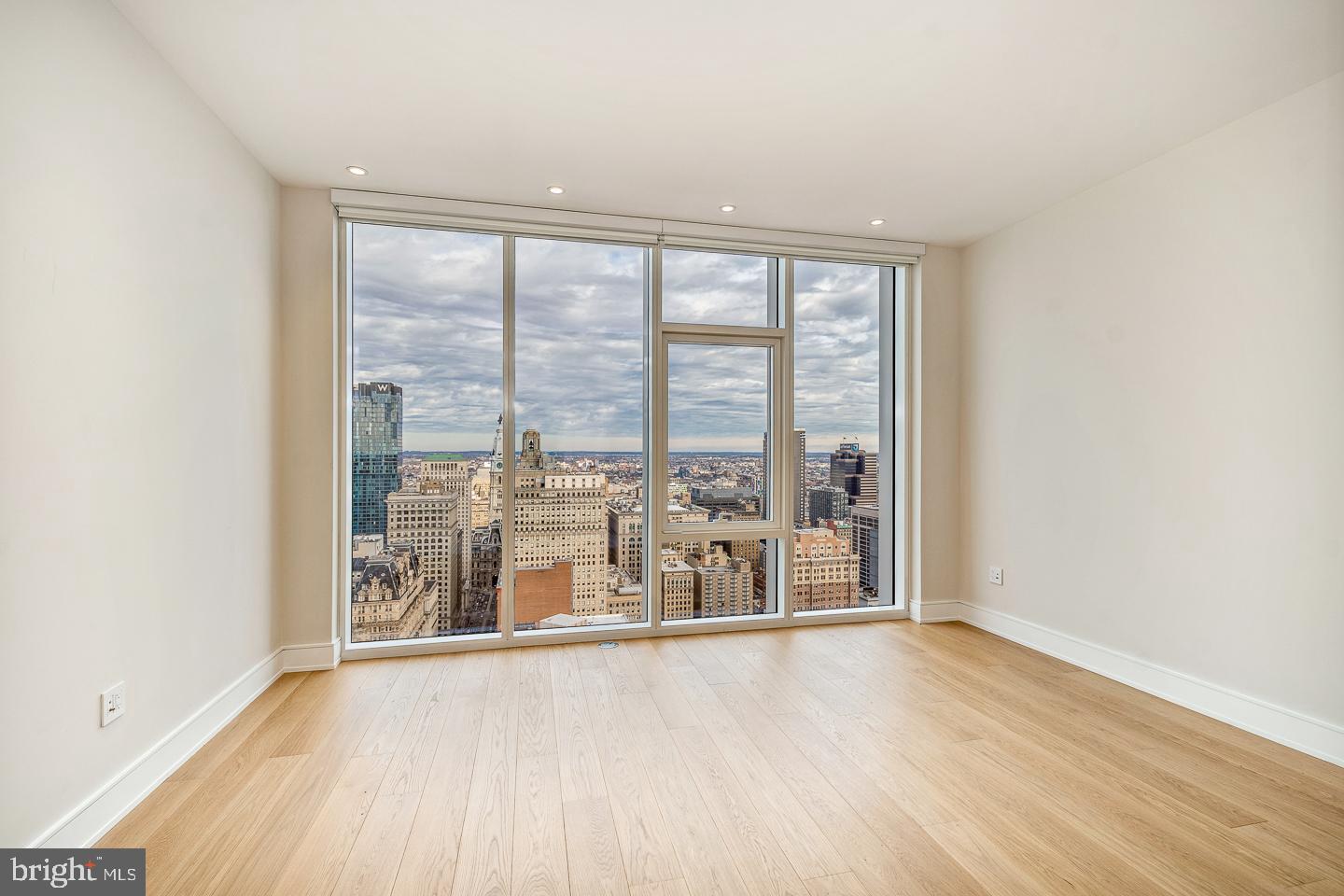 301 South Broad Street, Unit 4001 Philadelphia, PA 19107 - Photo 44 of 84 an empty room with wooden floor and windows