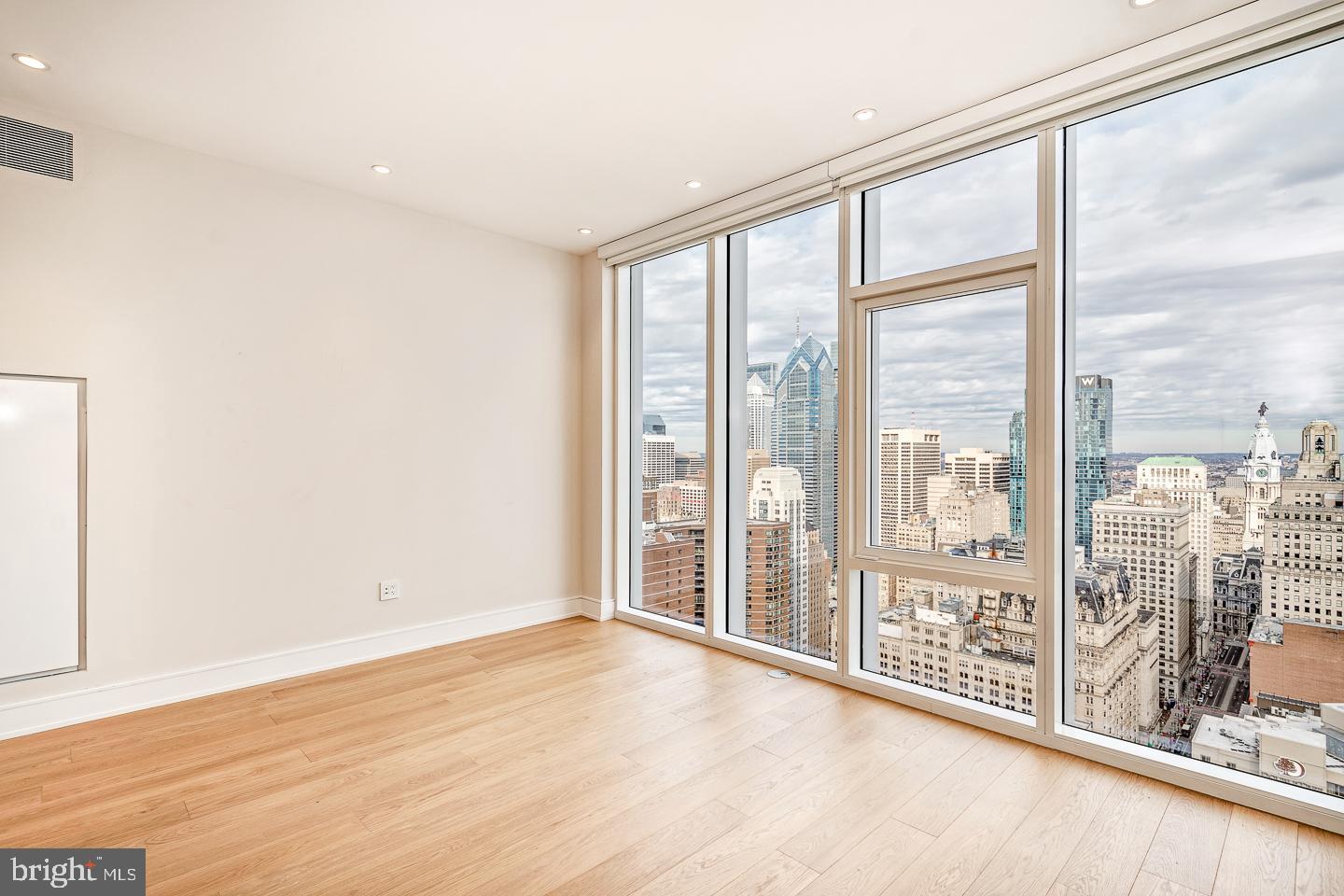 301 South Broad Street, Unit 4001 Philadelphia, PA 19107 - Photo 46 of 84 a view of an empty room with wooden floor and a window