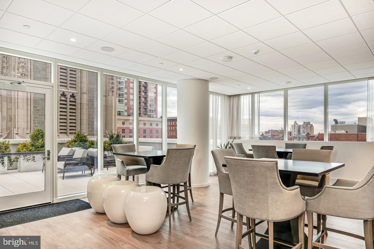301 South Broad Street, Unit 4001 Philadelphia, PA 19107 - Photo 77 of 84 a living room with furniture large windows and wooden floor