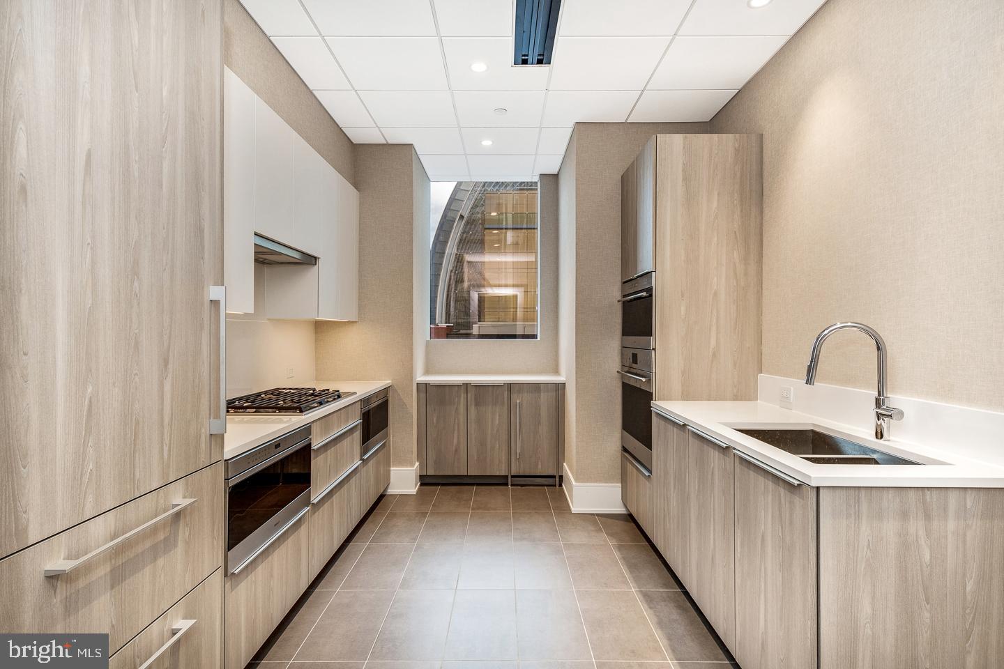 301 South Broad Street, Unit 4001 Philadelphia, PA 19107 - Photo 79 of 84 a kitchen with stainless steel appliances granite countertop a stove a sink and a refrigerator