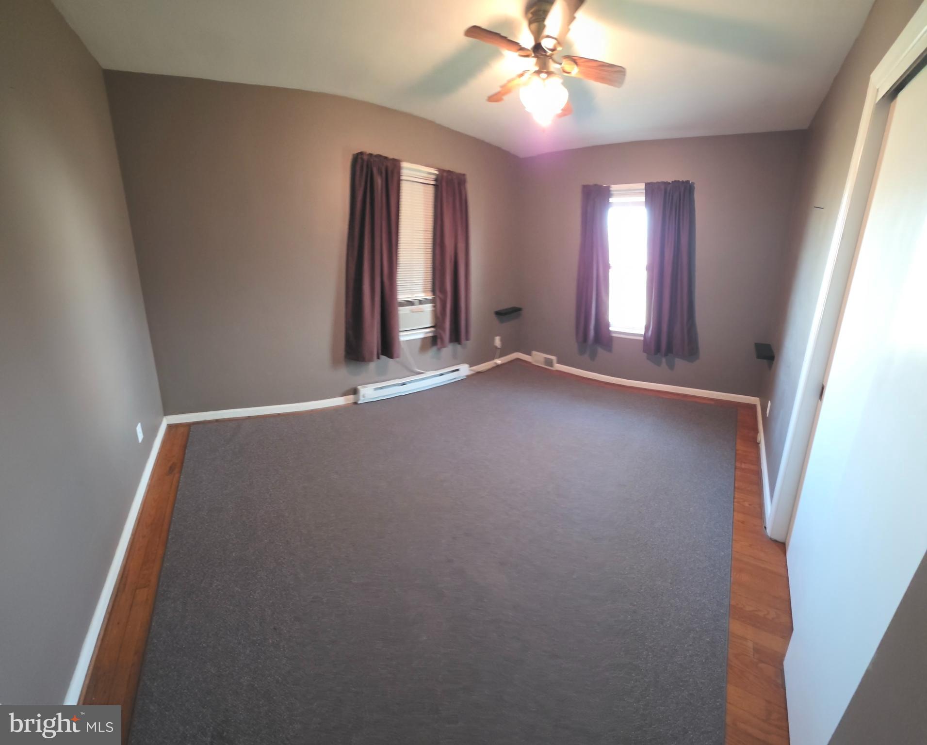 13517 Paradise Church Road Hagerstown, MD 21742 - Photo 6 of 15 an empty room with windows and fan