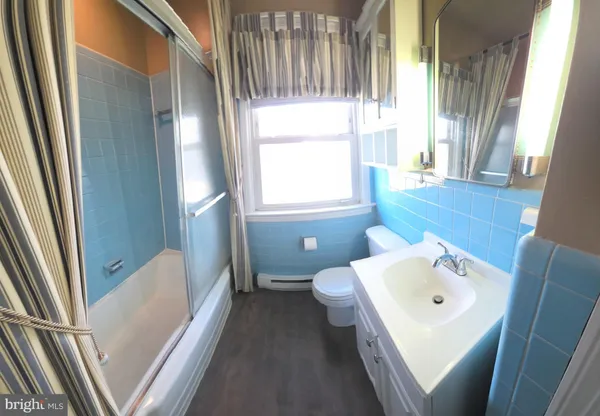 a bathroom with a sink a toilet and tub