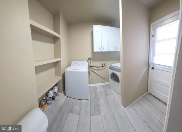 a room with wooden floor and white walls