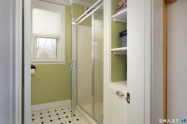 a bathroom with a shower and a sink