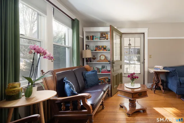 a living room with furniture and a floor to ceiling window