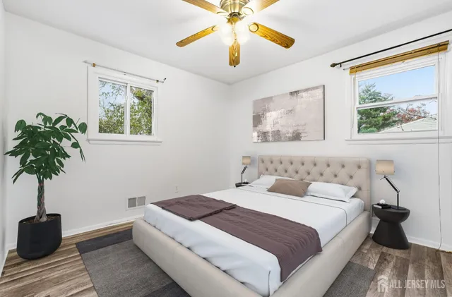 a bedroom with a large bed and a chandelier