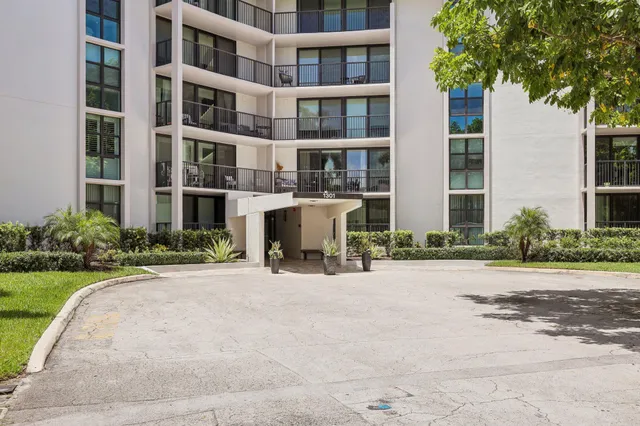 a view of a building with a yard and sitting space