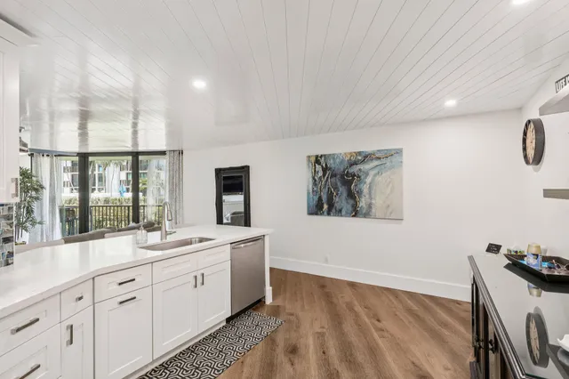 a spacious bathroom with a double vanity sink a mirror and a bathtub