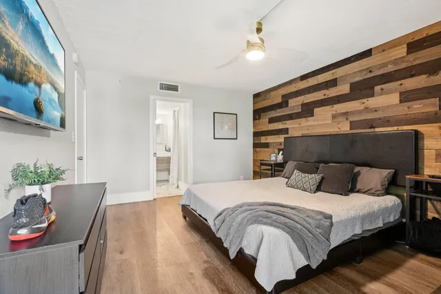 a bedroom with a bed and chair