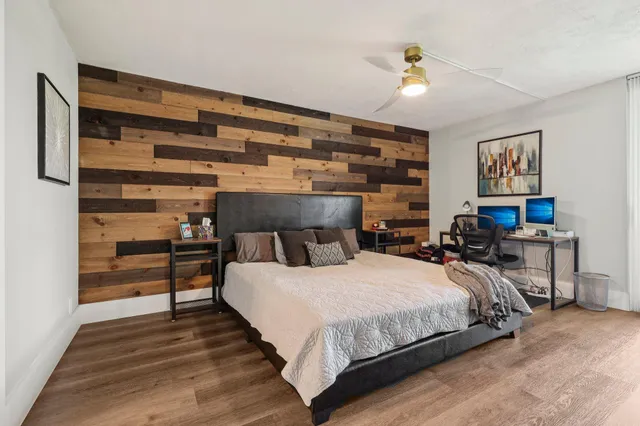 a bedroom with a bed and a chandelier