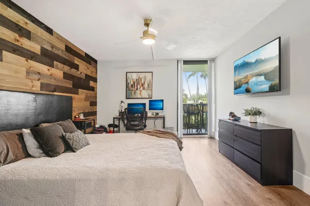 a bed room with a bed and a flat screen tv