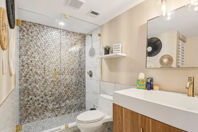 a bathroom with a sink a toilet and shower curtain