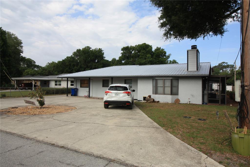 521 20th Street Southwest, Unit C Winter Haven, FL 33880 - Photo 1 of 18 a view of a car parked in front of a house
