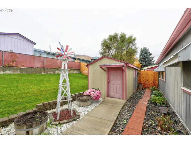 a backyard of a house with table and chairs