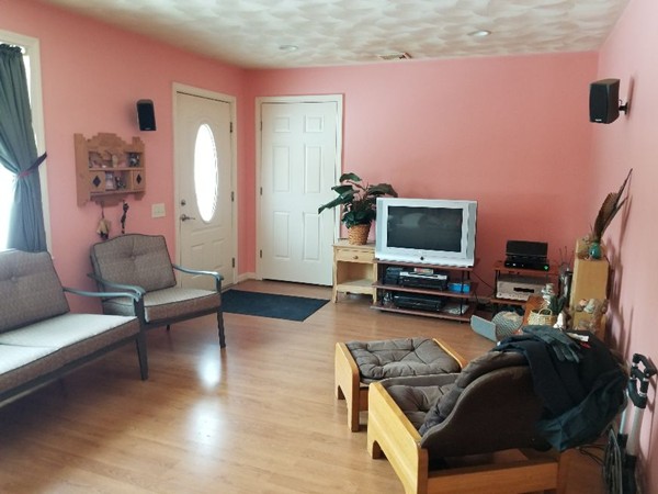 91 Meadow Road Townsend, MA 01469 - Photo 3 of 9 a living room with furniture and a flat screen tv
