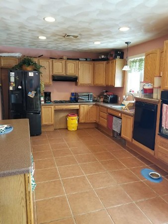 91 Meadow Road Townsend, MA 01469 - Photo 4 of 9 a large kitchen with a large counter top stainless steel appliances and cabinets