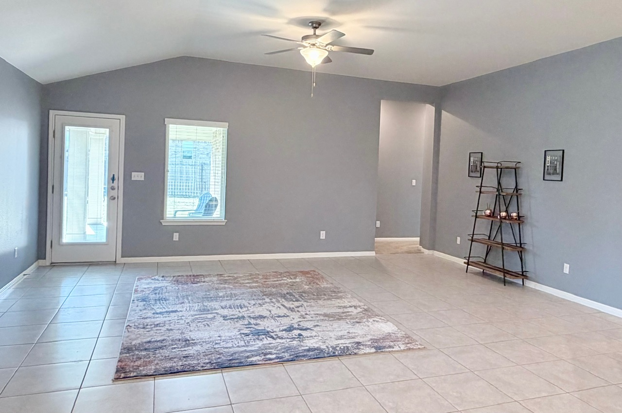 1005 Sundrops Street Leander, TX 78641 - Photo 11 of 39 a view of an empty room with window and chandelier fan