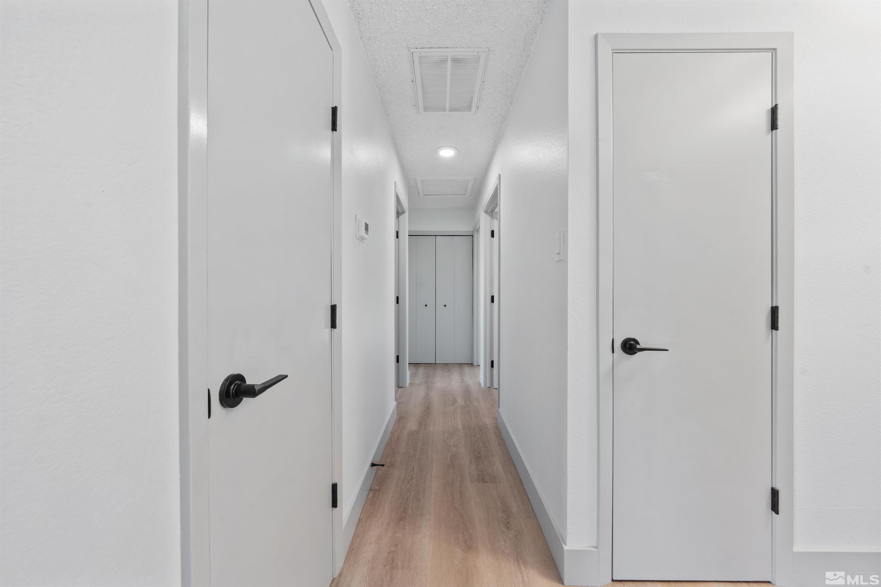 7750 Yorkshire Drive Reno, NV 89506 - Photo 11 of 33 a view of a hallway with wooden floor