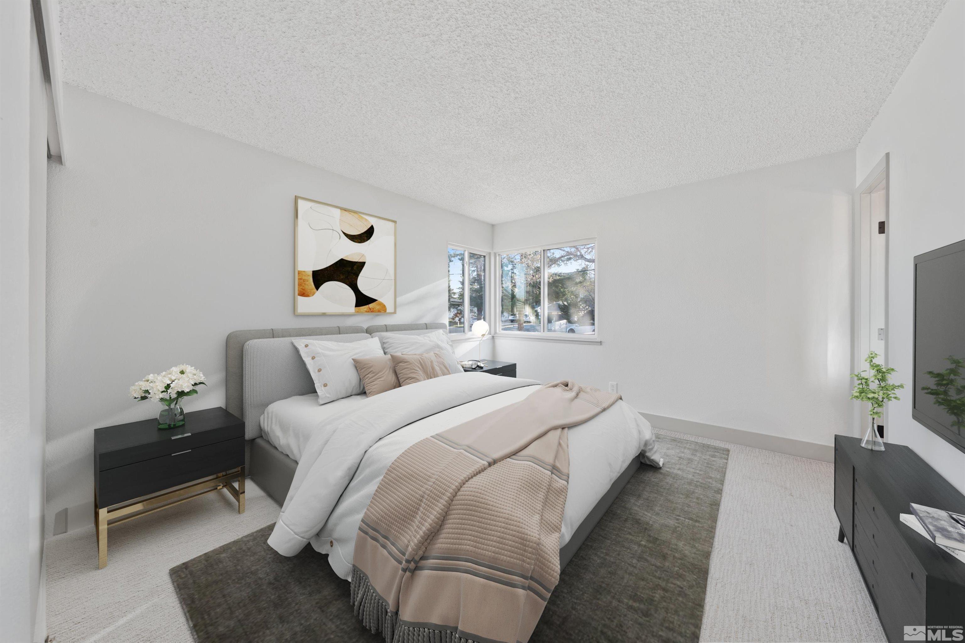 7750 Yorkshire Drive Reno, NV 89506 - Photo 12 of 33 a bedroom with bed large mirror and lamp