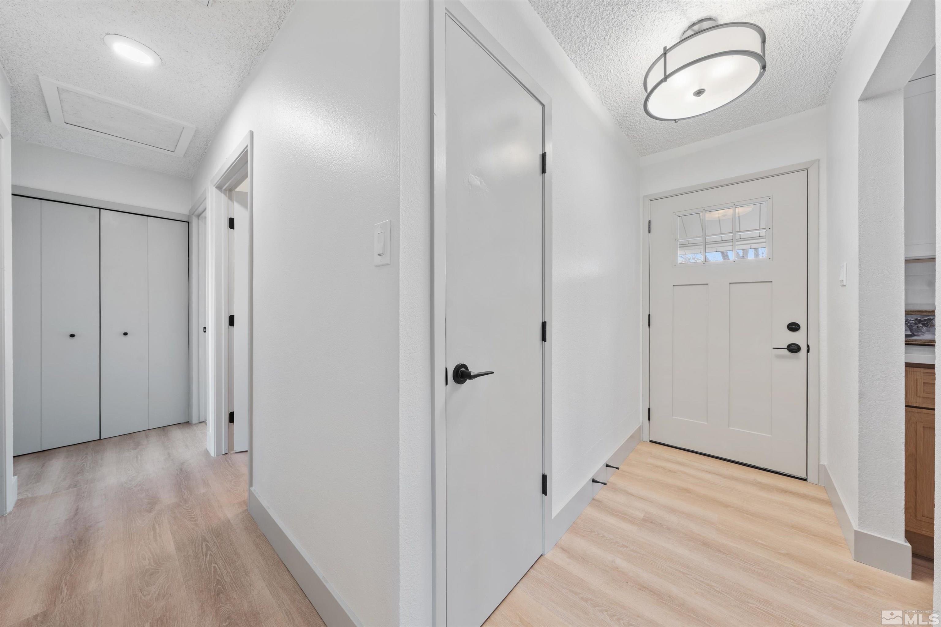 7750 Yorkshire Drive Reno, NV 89506 - Photo 2 of 33 a view of a hallway with wooden floor