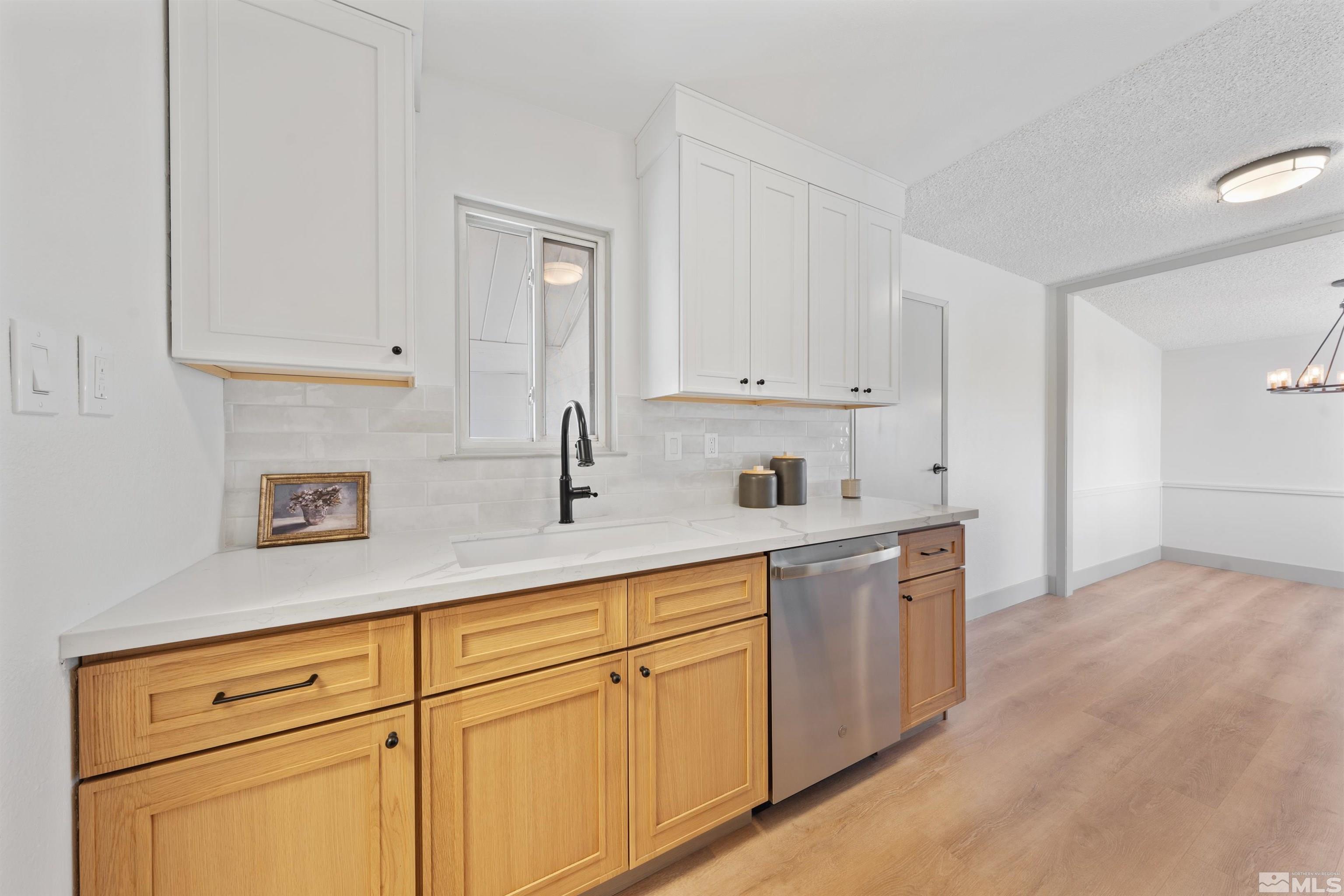 7750 Yorkshire Drive Reno, NV 89506 - Photo 3 of 33 a kitchen with white cabinets and white appliances