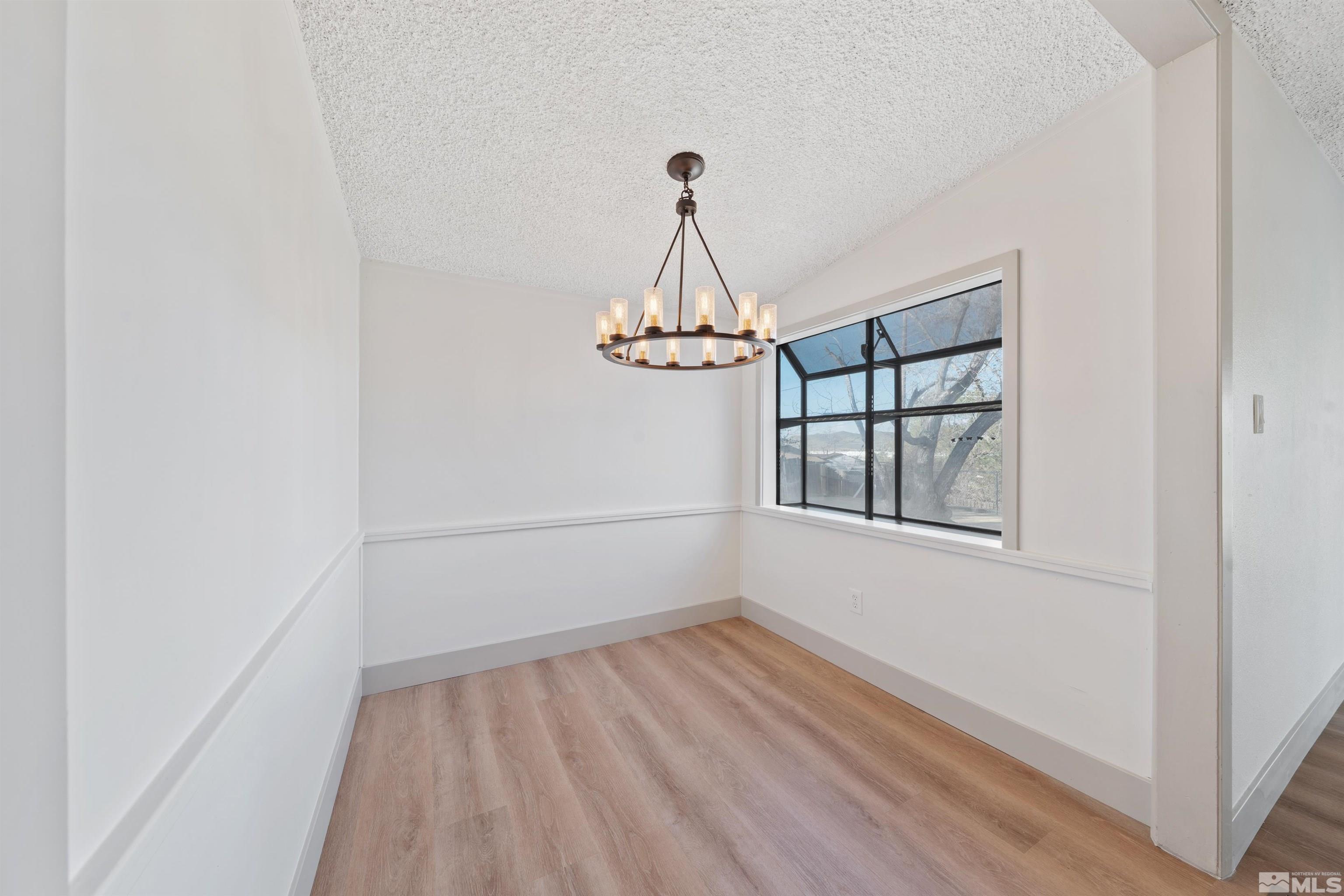 7750 Yorkshire Drive Reno, NV 89506 - Photo 7 of 33 wooden floor in an empty room with a window