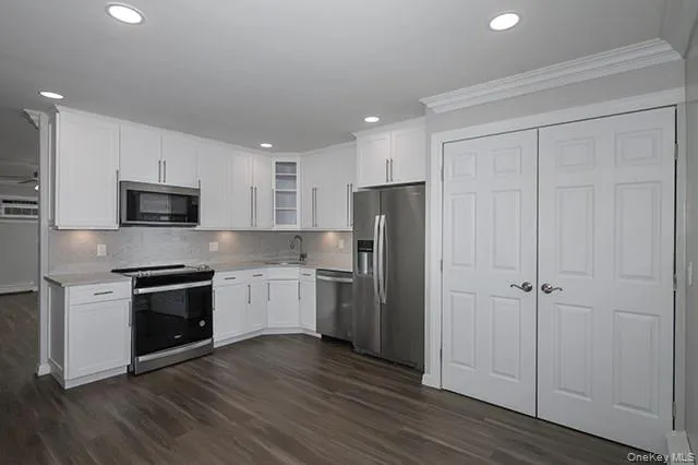 a kitchen with a sink stainless steel appliances and cabinets
